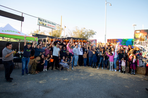 Community Members and Chispa staffers pose for a photo at a community event