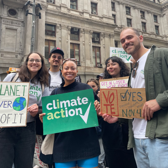 Climate Action activists hold signs at a march