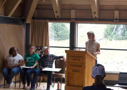 Oregon's Representative Dexter speaks at a podium about protecting public lands